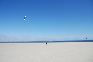 Berny flying kite on beach white sand